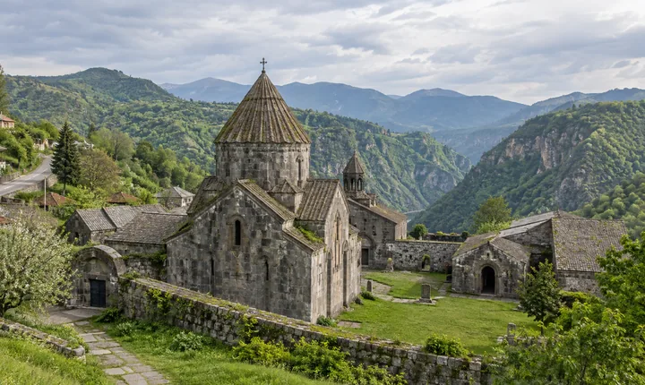 Weathered stone buildings of Haghpat Monastery overlooking the green Debed Canyon