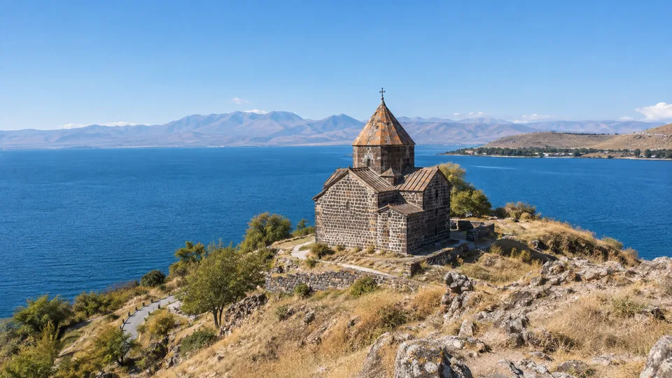 Sevanavank monastery above the blue water of Lake Sevan and its surrounding mountain rim