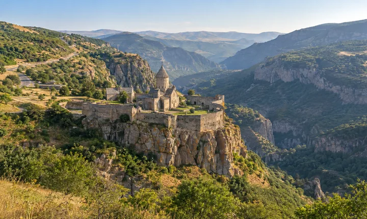 Tatev Monastery above the wooded Vorotan gorge with its winding approach road