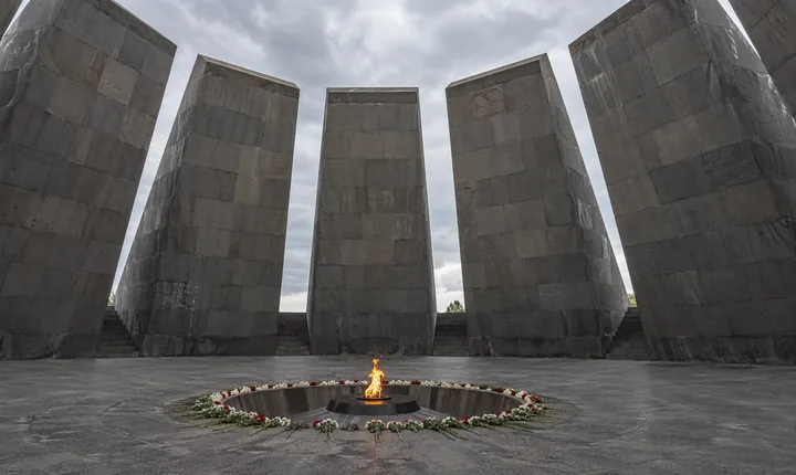 Eternal flame and flowers inside the circle of basalt slabs at Tsitsernakaberd in Yerevan