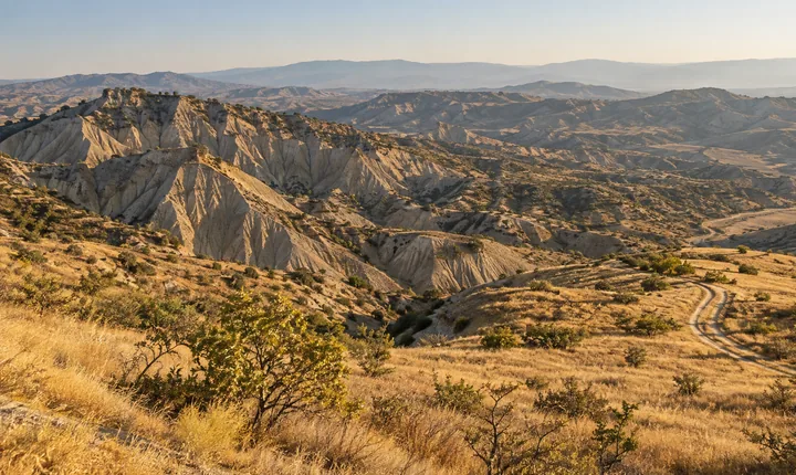 Eroded clay badlands and golden steppe in Georgia's Vashlovani Protected Areas