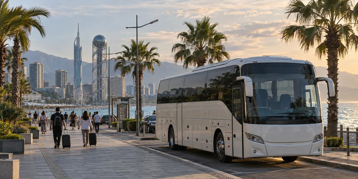 An intercity coach at a coastal curbside bay with palm trees and the Black Sea beyond
