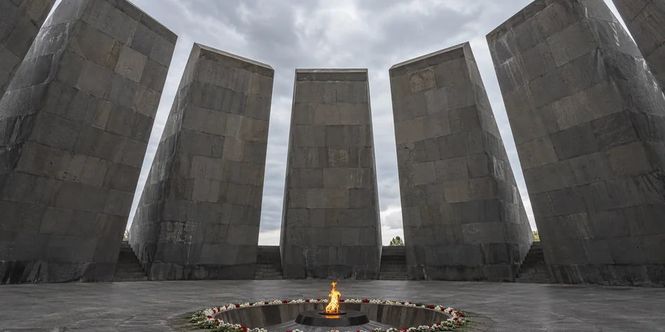 Eternal flame and flowers inside the circle of basalt slabs at Tsitsernakaberd in Yerevan